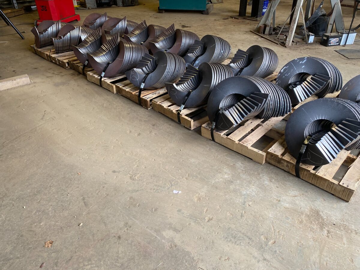 Row of formed flights on pallets in shop
